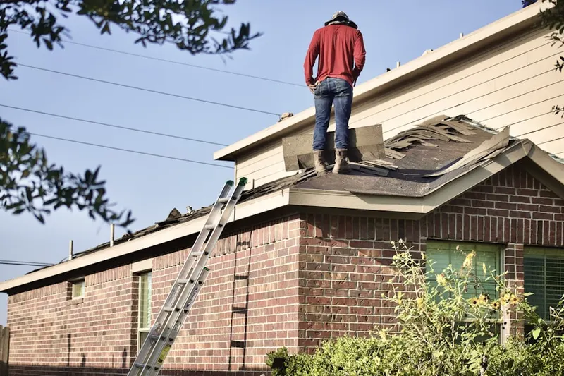 Professional roofer working on a residential roof in Bullard